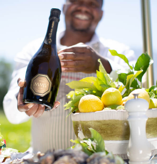 Staff member at Vergelegen standing next to a bowl of lemons whilst presenting the Vergelegen MMV wine.