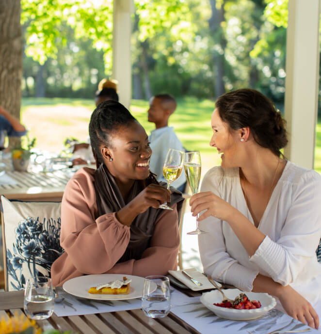 Two ladies cheersing over a glass of wine at Vergelengens restaurant